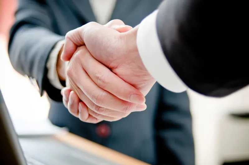 Business professionals shaking hands